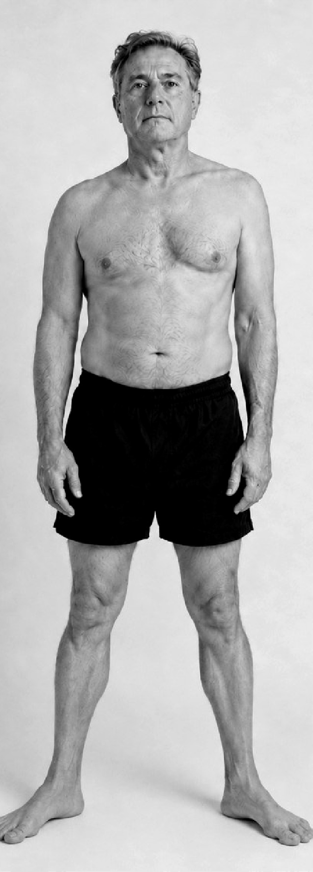 A man standing, seen from the front, hips and thighs