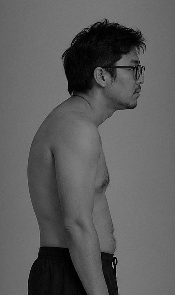 A man in side profile, neck and shoulders