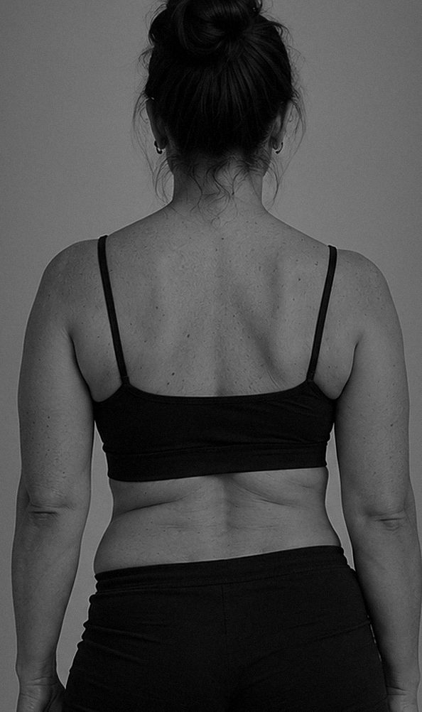 A woman seen from behind, shoulders and upper back